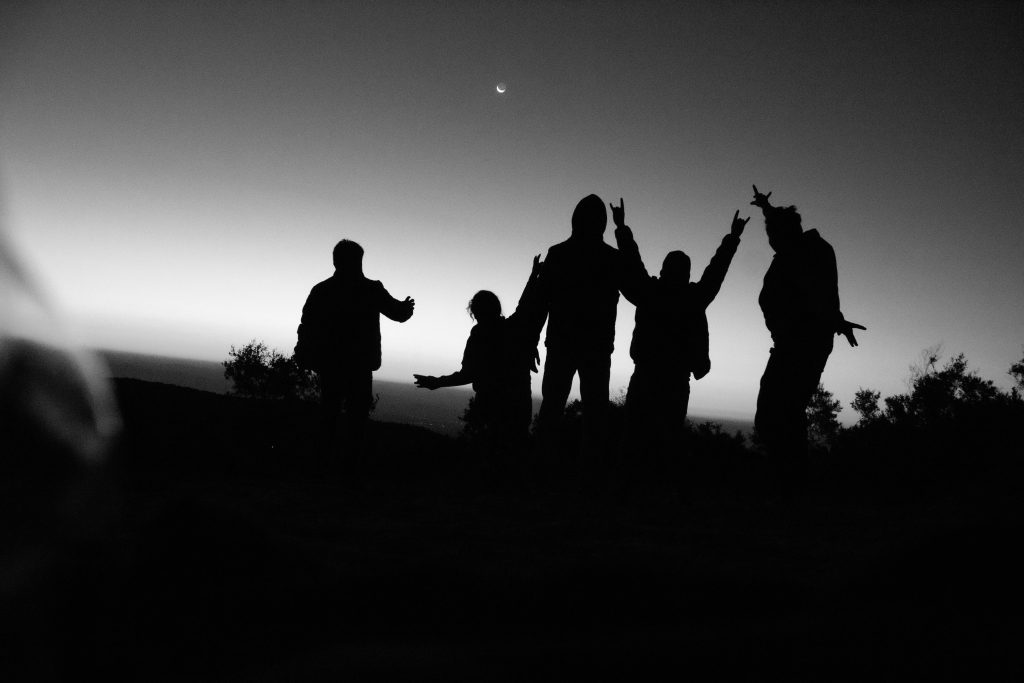 Group silhouetted against dawn in Tochimilco, Puebla, capturing a sense of adventure and unity.