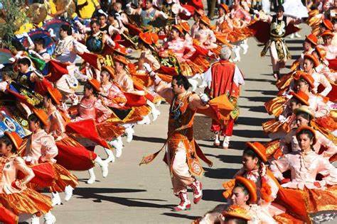 Dancers in vibrant traditional costumes performing during the La Tirana Festival in Chile, a religious celebration honoring the Virgin of Carmen with music, processions, and cultural dances.