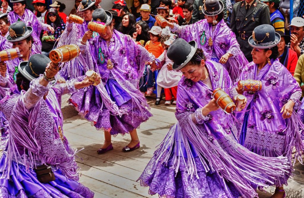 Dancers in ornate traditional costumes performing during the Festival de la Candelaria in Puno, Peru, a vibrant celebration of the Virgin of Candelaria with music, parades, and folkloric dances.