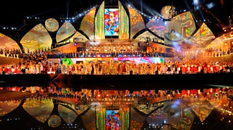 Performers in traditional costumes dancing on a brightly lit stage during the Fiesta Nacional de la Vendimia in Mendoza, Argentina, celebrating the grape harvest and winemaking culture.